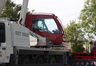 The crane driver carefully moves the load…