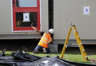 …while the builder uses hand signals to tell the crane driver what to do
