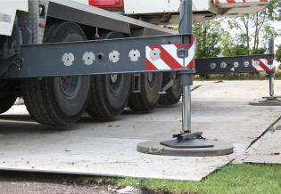 The crane has to be perfectly level and completely still, so its wheels are lifted off the ground by strong hydraulic jacks
